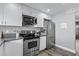 Contemporary kitchen featuring stainless steel appliances, modern cabinetry, and decorative backsplash at 4502 W Continental Dr, Glendale, AZ 85308
