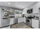 Well-lit kitchen featuring stainless steel appliances, white cabinetry, and a stylish backsplash design at 4502 W Continental Dr, Glendale, AZ 85308