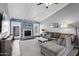 Bright living room with vaulted ceilings, modern decor, a decorative fireplace, and a comfortable sectional sofa at 4502 W Continental Dr, Glendale, AZ 85308