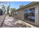 A spacious patio with a sliding glass door and mature trees offering shade at 4502 W Continental Dr, Glendale, AZ 85308