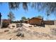 View of backyard with desert landscaping, patio, and charming wood bridge at 4516 E Willow Ave, Phoenix, AZ 85032