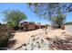 Large backyard features desert landscaping, stone patio, and decorative rock features at 4516 E Willow Ave, Phoenix, AZ 85032