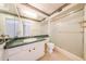 A bathroom features a green marble countertop, white cabinets, and a glass shower at 4516 E Willow Ave, Phoenix, AZ 85032