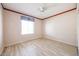 Bright, vacant bedroom with wood-look flooring and ceiling fan at 4516 E Willow Ave, Phoenix, AZ 85032