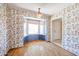 A dining room features vibrant wallpaper, a bay window, and wood floors at 4516 E Willow Ave, Phoenix, AZ 85032