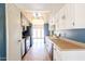 A well-lit kitchen featuring white cabinets, tan countertops, and black appliances at 4516 E Willow Ave, Phoenix, AZ 85032