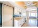 Functional eat-in kitchen with white cabinets, breakfast nook, and access to backyard at 4516 E Willow Ave, Phoenix, AZ 85032