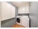Convenient laundry room with modern appliances and overhead storage cabinets at 4516 E Willow Ave, Phoenix, AZ 85032