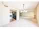 Open-concept living space leading to kitchen with neutral colors and tile flooring at 4516 E Willow Ave, Phoenix, AZ 85032