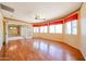Well-lit living room with wood floors, large windows and doorway to an adjoining room at 4516 E Willow Ave, Phoenix, AZ 85032