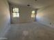 Unfinished bedroom features two windows, providing ample natural light and views at 46869 W Old Timer Rd, Maricopa, AZ 85139