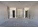 Bright, unfinished room with two closet openings and a doorway at 46869 W Old Timer Rd, Maricopa, AZ 85139