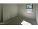Unfinished bedroom features a window and closet providing potential for customization and storage at 46869 W Old Timer Rd, Maricopa, AZ 85139