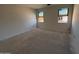 A spacious bedroom with two windows for natural light at 46869 W Old Timer Rd, Maricopa, AZ 85139