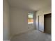 Unfinished bedroom with a window and sliding closet doors, offering potential for a personalized space at 46869 W Old Timer Rd, Maricopa, AZ 85139