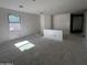 Spacious unfinished living room with a window and two doorways, providing flexible design options at 46869 W Old Timer Rd, Maricopa, AZ 85139