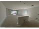 Spacious unfinished living room with sliding glass doors and a window for ample natural light at 46869 W Old Timer Rd, Maricopa, AZ 85139