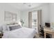 Comfortable bedroom with a neutral color scheme, complemented by a desk and ample natural light at 4711 S Vapor --, Mesa, AZ 85212