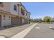 Exterior view of townhomes featuring stucco siding, garages, and well-maintained landscaping at 4711 S Vapor --, Mesa, AZ 85212