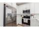Bright kitchen with stainless steel appliances, white cabinets, subway tile backsplash, and light countertops at 4711 S Vapor --, Mesa, AZ 85212