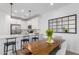 Modern kitchen with white cabinets, stainless steel appliances, and an adjacent dining area at 4711 S Vapor --, Mesa, AZ 85212