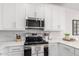 A bright kitchen featuring white cabinets, stainless steel appliances, and a light backsplash and countertops at 4711 S Vapor --, Mesa, AZ 85212