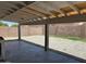 Spacious covered backyard with a gravel area surrounded by a block wall, offering a private outdoor space at 4741 N 85Th Ave, Phoenix, AZ 85037