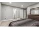 Bedroom with wood-look floors, access to the ensuite bathroom, and a closet at 4741 N 85Th Ave, Phoenix, AZ 85037