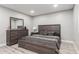 Bedroom features wooden furniture, wood look flooring, recessed lights, and neutral walls at 4741 N 85Th Ave, Phoenix, AZ 85037