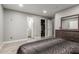 Bedroom showing access to an ensuite bathroom and closet, with wood-look flooring at 4741 N 85Th Ave, Phoenix, AZ 85037