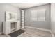 Bright bedroom featuring a well-lit vanity with drawers and a stylish, modern shelf at 4741 N 85Th Ave, Phoenix, AZ 85037
