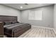 Comfortable bedroom featuring a wooden bed frame, and light wood-look flooring at 4741 N 85Th Ave, Phoenix, AZ 85037