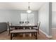 Formal dining room with a large table and chairs under a decorative light fixture at 4741 N 85Th Ave, Phoenix, AZ 85037