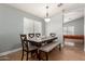 Dining area featuring a table set with chairs and bench, with a pool table in the background at 4741 N 85Th Ave, Phoenix, AZ 85037
