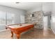 Bright game room showcasing billiard table and stone accent wall feature at 4741 N 85Th Ave, Phoenix, AZ 85037