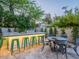 Outdoor space showcasing a custom kitchen bar with seating and an outdoor dining area surrounded by lush plants at 4748 E Redfield Rd, Phoenix, AZ 85032