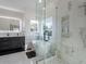 Bright bathroom featuring a soaking tub, glass-enclosed shower, and modern vanity with sleek fixtures at 4748 E Redfield Rd, Phoenix, AZ 85032