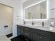 Stylish bathroom with dual vanities, sleek fixtures, and an illuminated mirror at 4748 E Redfield Rd, Phoenix, AZ 85032