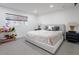 Bright bedroom with a king-sized bed, black bedside tables, and plush carpet at 4748 E Redfield Rd, Phoenix, AZ 85032