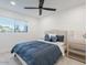 Bright bedroom with a king-sized bed, modern bedside tables, and a large window at 4748 E Redfield Rd, Phoenix, AZ 85032
