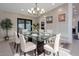 Elegant dining room with a glass table, modern chandelier, and stylish decor at 4748 E Redfield Rd, Phoenix, AZ 85032