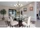 Elegant dining room with a glass table, modern chandelier, and stylish decor at 4748 E Redfield Rd, Phoenix, AZ 85032