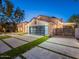 Beautiful two-story home with a modern garage door, lush landscaping, and a well-maintained lawn at 4748 E Redfield Rd, Phoenix, AZ 85032