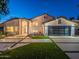 Stunning two-story home with a modern garage door, lush landscaping, and manicured lawn at 4748 E Redfield Rd, Phoenix, AZ 85032