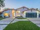 Stunning two-story home featuring a well manicured front yard and a modern, glass-paneled garage door at 4748 E Redfield Rd, Phoenix, AZ 85032