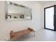 Stylish foyer featuring a large mirror, contemporary bench, and a modern front door at 4748 E Redfield Rd, Phoenix, AZ 85032