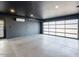 Spacious garage with black walls, bright lighting, and modern frosted glass garage door at 4748 E Redfield Rd, Phoenix, AZ 85032
