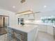 Bright kitchen with white cabinetry, stainless steel appliances, and a large marble island with seating at 4748 E Redfield Rd, Phoenix, AZ 85032