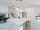 Bright kitchen with marble island, stainless steel appliances, and view into the dining room and staircase at 4748 E Redfield Rd, Phoenix, AZ 85032