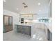 Bright kitchen with white cabinetry, stainless steel appliances, and a large marble island with seating at 4748 E Redfield Rd, Phoenix, AZ 85032